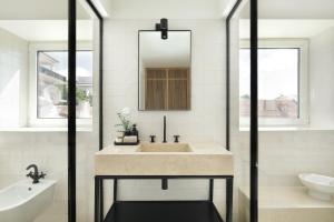 a bathroom with a sink and a mirror at Villa Sofia Cascais in Cascais