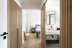 a bathroom with a sink and a bedroom with a bed at Villa Sofia Cascais in Cascais