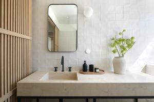 a bathroom with a sink and a mirror at Villa Sofia Cascais in Cascais