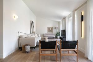 a living room with two chairs and a couch at Villa Sofia Cascais in Cascais