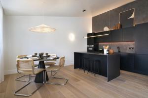 a kitchen with a table and chairs in a room at Villa Sofia Cascais in Cascais
