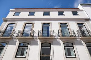 a white building with balconies on it at Villa Sofia Cascais in Cascais
