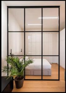 a bedroom with a bed and a potted plant at Palace of Culture Loft Apartment in Warsaw
