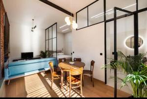 a dining room with a blue table and chairs at Palace of Culture Loft Apartment in Warsaw