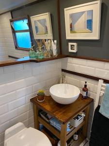 a bathroom with a sink and a toilet at Cosy Narrowboat Benedict, Clarence Dock Leeds in Hunslet