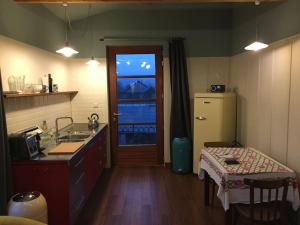 a kitchen with a sink and a refrigerator and a door at ziggy's room with a view in Heyd +30 photos