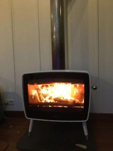 a fireplace with a fire in it in a room at ziggy's room with a view in Heyd