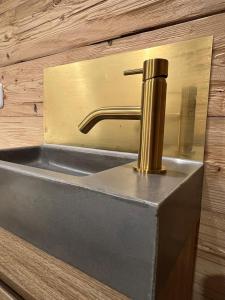 a sink in a bathroom with a metal faucet at Ferienwohnung Lechraum in Waal in Waal