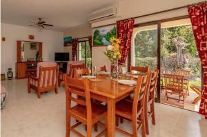 a dining room with a wooden table and chairs at Villa Alegria in Loulé