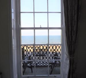 an open window with a view of the ocean at The Edenhurst Guesthouse in Weymouth