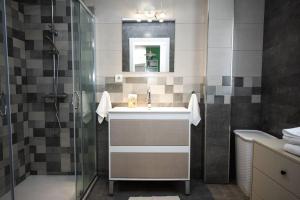 a bathroom with a sink and a shower at 4 Mares Apartamentos A in Loredo +60 photos