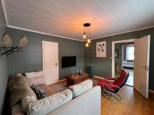 a living room with a couch and a tv at High Noon Westernranch Holidayhouse in Ljusdal