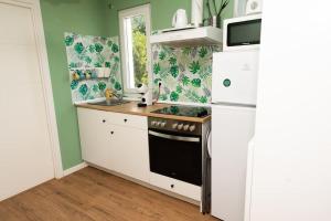 a kitchen with a white refrigerator and a stove at 4 Mares Apartamentos A in Loredo