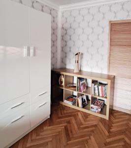 a room with a book shelf with books at Mokka Apartament in Kielce