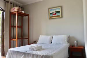 a bedroom with a white bed with towels on it at Casa Fiorelli in Cunha