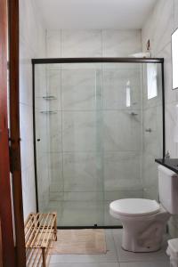 a glass shower in a bathroom with a toilet at Casa Fiorelli in Cunha +19 photos
