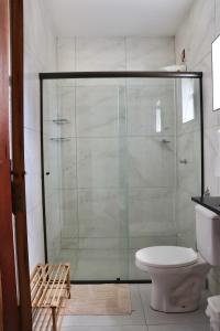 a glass shower in a bathroom with a toilet at Casa Fiorelli in Cunha