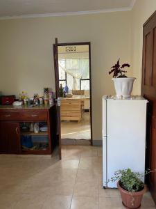 a kitchen with a white refrigerator in a room at Wonders Hostel in Arusha