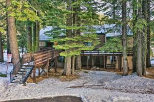 a house in the woods with a staircase in the snow at Pinecrest Retreat with Fireplace! in Pinecrest