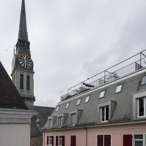 a tall clock tower with a steeple on a building at numa I Craft Apartments in Zürich