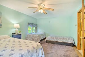 a bedroom with two beds and a ceiling fan at Pet-Friendly Gilford Home 3 Mi to Gunstock and Lake in Gilford