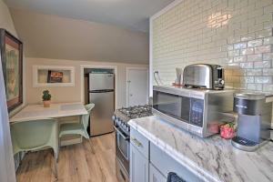 a kitchen with a counter top with a stove and a microwave at Spacious Lexington Studio 2 Miles to Rupp Arena in Lexington