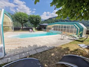 a house with a swimming pool and a building at chateau d'escart in Arvillard