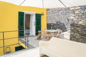 a dog sitting on the patio of a house at Vespa Apartments in Moneglia