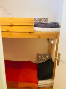 a room with two bunk beds in a room at Ski apartment 3 valleys in Les Menuires