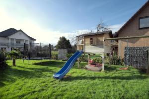 a playground with a slide in a yard at Modern Wohnen I Smart TV I Terrasse I 2x Parkplatz I 2 Schlafzimmer I 6 Schlafplätze in Bad Oeynhausen