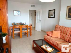 ein Wohnzimmer mit einem Sofa und einem Tisch in der Unterkunft Apartamento Apolo XVII 31 - Grupo Turis in Calpe