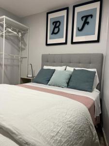 a bedroom with a large bed with two pictures on the wall at BF Suites & Apartments in Porto