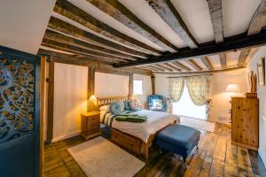 a bedroom with a bed and a chair in it at Flushing House, Rye in Rye