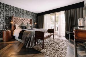 a bedroom with a large bed and a chair at Derwent Manor Boutique Hotel in Consett