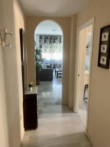 a hallway of a living room with a couch and a table at Apartamento Liru Bormujos, a 5 minutos de Sevilla in Bormujos