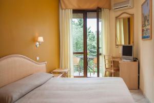 Postel nebo postele na pokoji v ubytování Hotel Orion