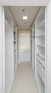 a walk in closet with white closets at N3A1 - New, Nice, for Long and Short Stay in Asunción
