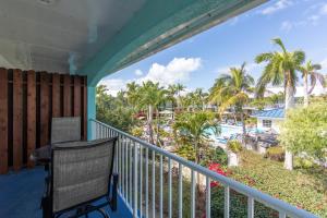 a balcony with a desk and a view of a resort at Island Club Turks & Grace Bay Place in Grace Bay