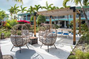 a patio with two chairs and a table and a pavilion at Island Club Turks & Grace Bay Place in Grace Bay