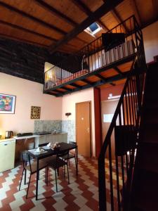 a kitchen and dining room with a table and a staircase at Al Mare In Città in Catania