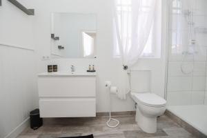 a white bathroom with a toilet and a shower at Hostellerie LE PANEL in Mandelieu-La Napoule