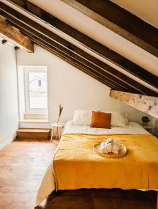 a bedroom with a bed with a plate on it at Cozy 3 BR Home - Close to Beach in Lourinhã