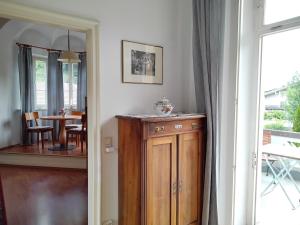 a room with a wooden cabinet and a dining room at ciao-aschau Haus zur Burg Ap108 Weber in Aschau