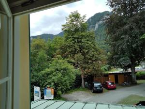 a view from a window of a yard with cars parked at ciao-aschau Haus zur Burg Ap102 Biedermann in Aschau