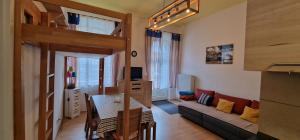 a living room with a loft bed and a couch at ciao-aschau Haus zur Burg Ap104 Pabst in Aschau