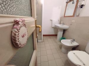 a bathroom with a baseball glove hanging on the door at Al Mare In Città in Catania