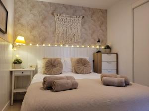 a bedroom with a large bed with lights above it at "COZY LOFT", TERRACE, PARKING and SWIMMING POOL in Málaga