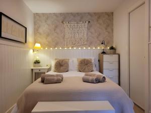 a bedroom with a large bed with lights on it at "COZY LOFT", TERRACE, PARKING and SWIMMING POOL in Málaga