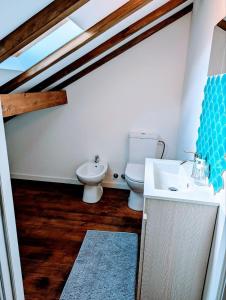 a bathroom with a toilet and a sink in a room at Cozy 3 BR Home - Close to Beach in Lourinhã