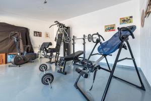 a gym with several exercise equipment in a room at [Lusso e relax] con piscina a 2 minuti dal mare in Miami Platja